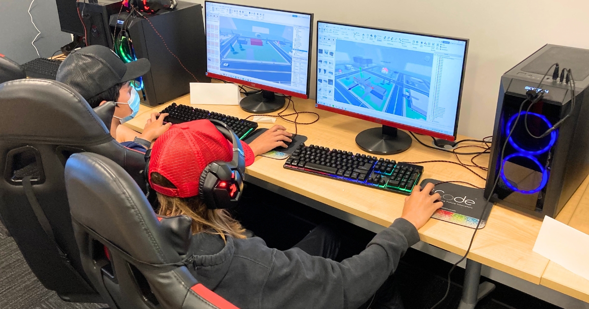 Two students learning game development using the Roblox Editor at iCode Bellevue